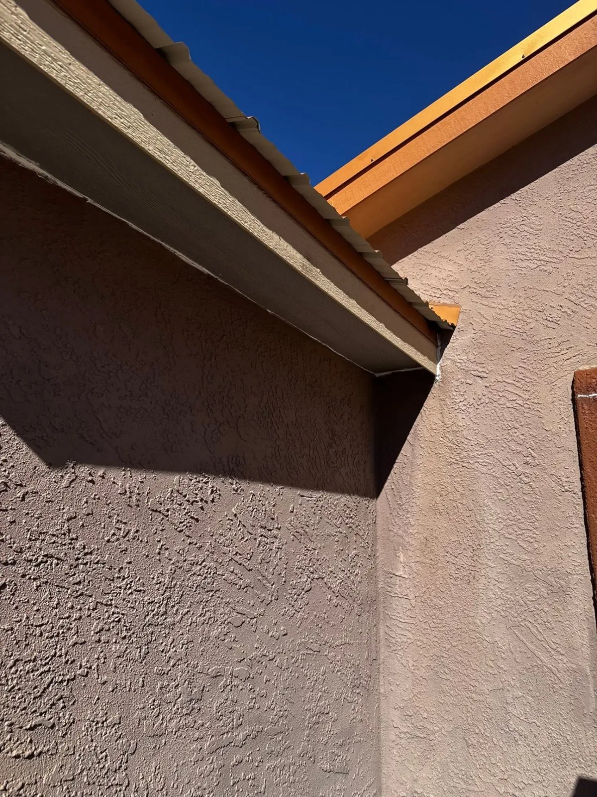 Repainted stucco eaves and fascia
